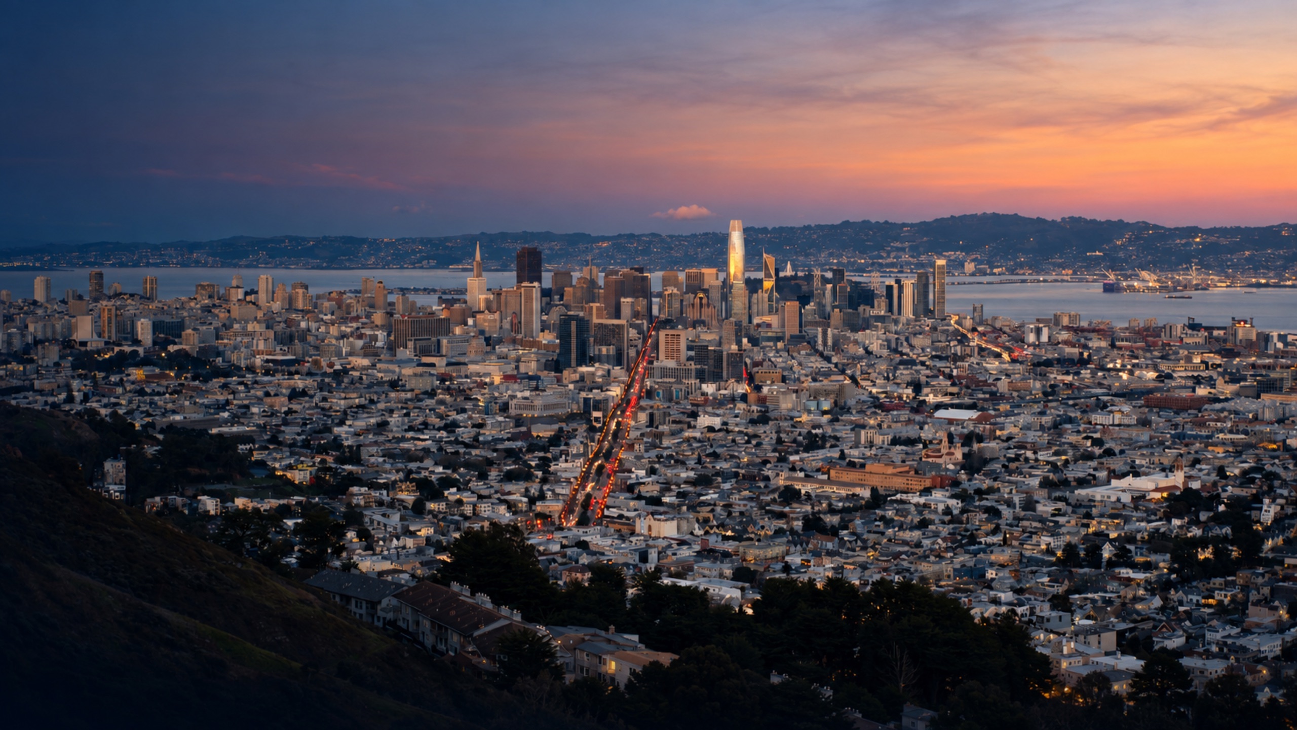San Francisco neighborhoods and downtown skyline at dusk, viewed along Market Street